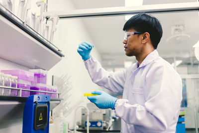 Side view of young man working in laboratory