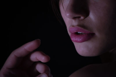 Close-up of woman lips against black background