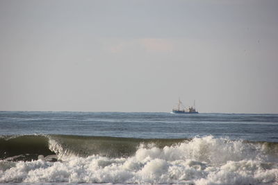 Boat sailing in sea against sky