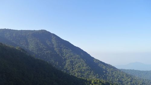 Scenic view of mountains against clear blue sky