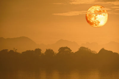 Scenic view of silhouette mountains against sky during sunset