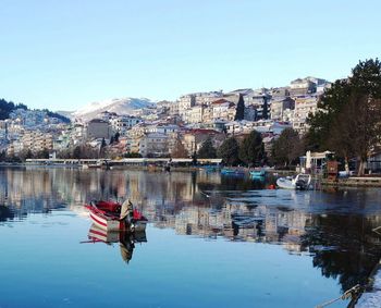 Reflection of buildings in city against sky