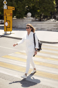 Full length of woman standing on road