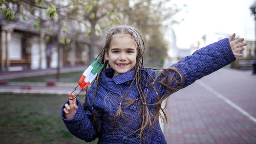 Portrait of smiling girl standing outdoors