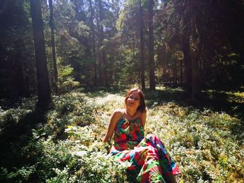 Portrait of a smiling young woman in forest