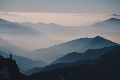 Scenic view of silhouette mountains against sky during sunset