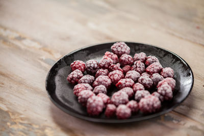 Close-up of frozen raspberries on plate