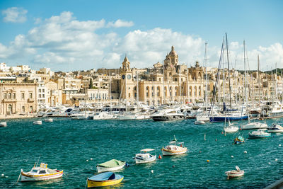 Sailing boats in harbor in front of historical scenery in malta