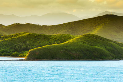 Scenic view of lake and mountains against sky