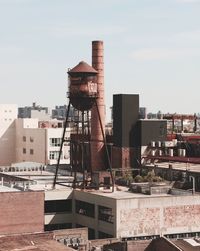 Factory against sky in city