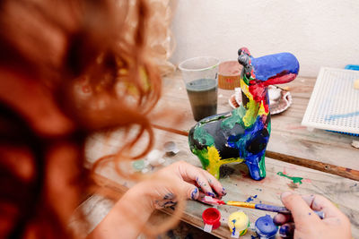 Midsection of woman painting on table