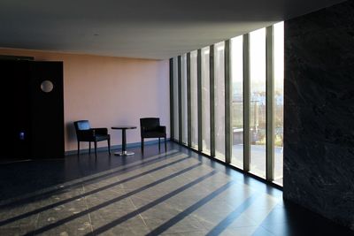 Empty chairs and table against window at home