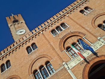 Low angle view of buildings against blue sky