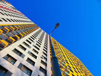 Low angle view of modern building against clear blue sky