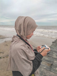 A woman with camera in beach