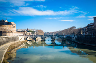 View of bridge in old town against cloudy sky