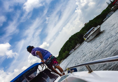 Man in boat against sky