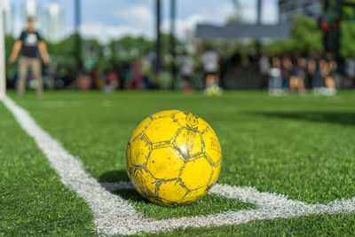 Close-up of yellow ball on field