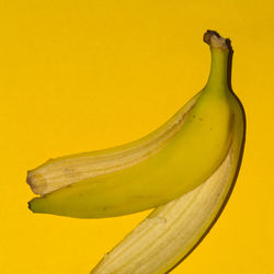 Close-up of banana against yellow background