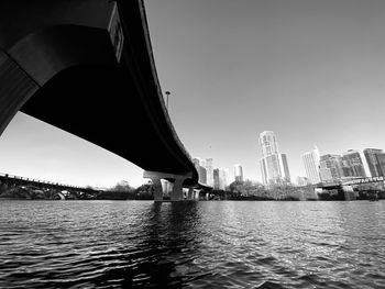 Bridge over river with buildings in background