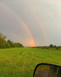 Scenic view of rainbow over field