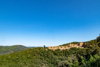Scenic view of mountains against clear blue sky