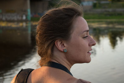 Looking into the distance, a thoughtful girl of slavic appearance with her mouth open at sunset