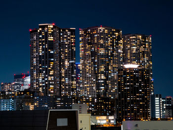 Illuminated buildings in city at night