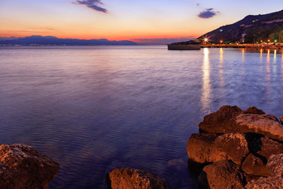 Scenic view of sea against romantic sky at sunset