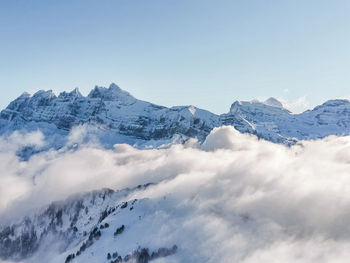 Scenic view of snowcapped mountains against clear sky