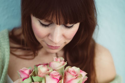 Close-up of beautiful woman with pink roses