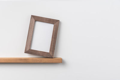 Wooden chair against white wall at home