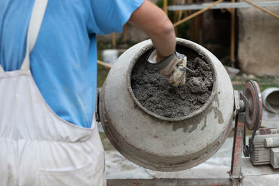 Midsection of man working in workshop