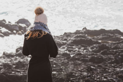 Rear view of woman standing on beach