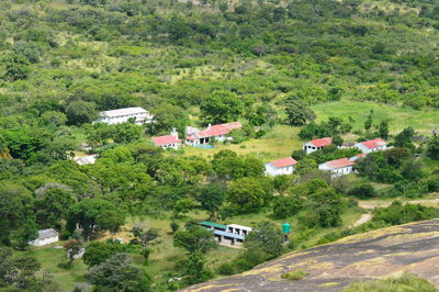 High angle view of houses amidst trees and buildings