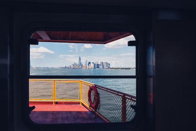 View of sea seen through window