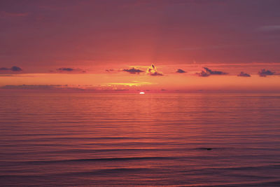 Scenic view of sea against romantic sky at sunset