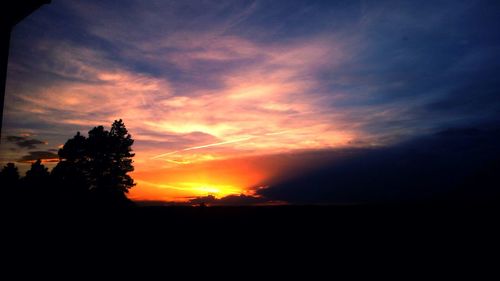 Silhouette landscape against sunset sky