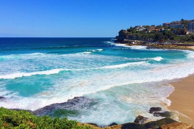 Scenic view of sea against clear blue sky