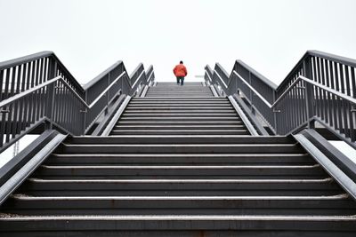 Low angle view of man walking up stairs