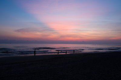 Scenic view of beach against sky during sunset