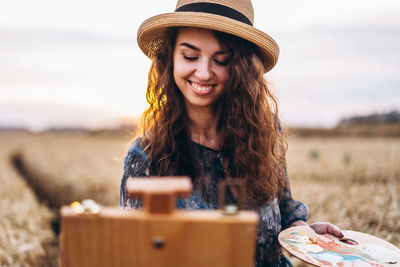 Smiling young woman wearing hat