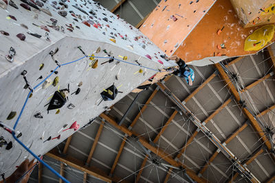 Low angle view of man climbing on wall