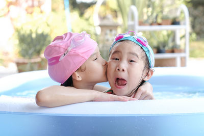 Portrait of cute girl with swimming pool