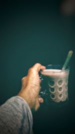 Close-up of hand holding coffee cup