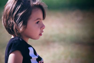 Close-up of cute girl looking away in playground