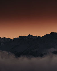 Scenic view of silhouette mountains against sky during sunset