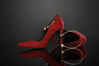 Close-up of red high heels on table