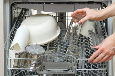 Midsection of man using utensils at home