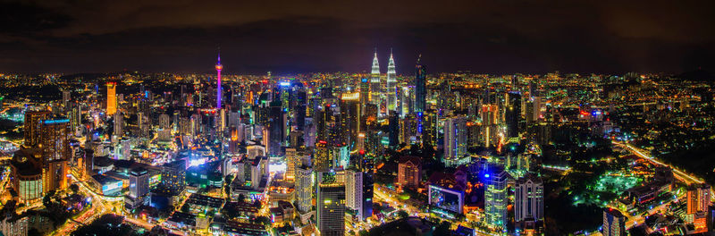 High angle view of city lit up at night